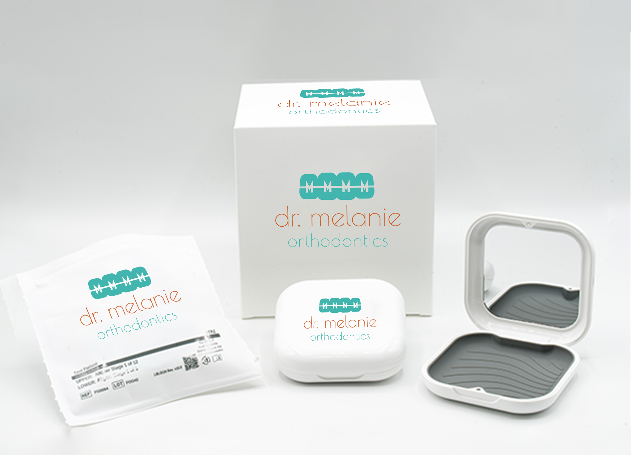 Custom Dr. Melanie Orthodontics packaging with a branded box, aligner pouch, and open and closed aligner cases.
